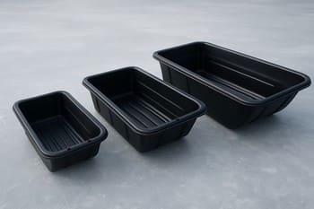 Three ice sleds of different sizes lined up on night ice